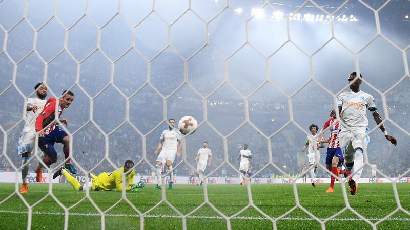 Antoine Griezmann scores Atlético madrid’s second against Marseille. Photograph: Matthias Hangst/Getty