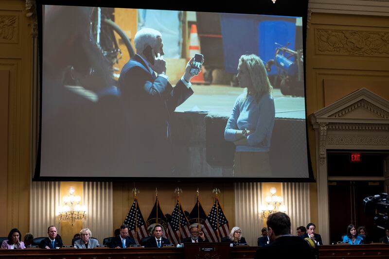 A photograph of former vice-president Mike Pence looking at a tweet by former president Donald Trump while he and his staff take shelter is displayed during a hearing of the House Select Committee. 