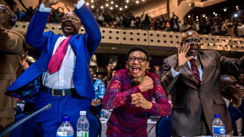 Mugabe resigns: Zimbabwean politicians celebrate in parliament in Harare. Photograph:  Jekesai Njikizana/AFP/Getty