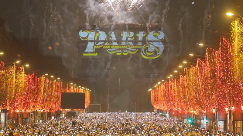 Fireworks illuminate the sky over the Arc de Triomphe during the New Year’s Day celebrations on the Champs Elysees, in Paris. Photograph: AP