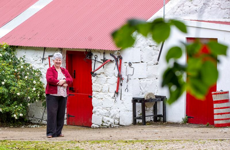 Bed and Breakfast owner Margaret McQuirkin beside outbuildings at her home at Coolnagrock on Rathlin Island. Photograph: Paul Faith