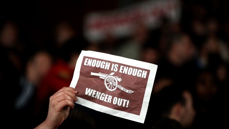 An Arsenal fan holds up a banner in protest against manager Wenger. Photo: Nick Potts/PA Wire