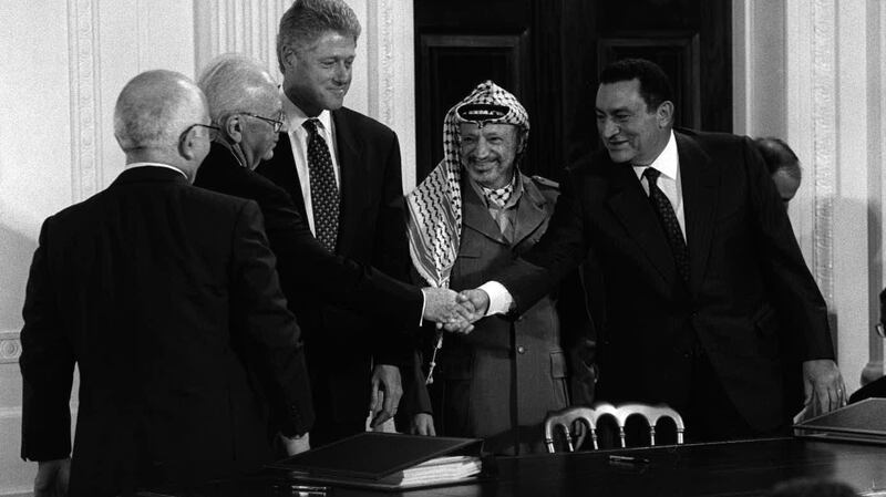President Hosni Mubarak of Egypt, right, shakes hands with prime minister Yitzhak Rabin of Israel as King Hussein of Jordan, left, US president Bill Clinton, third from left, and Palestinian leader Yasser Arafat look on before the signing of a peace accord at the White House on September 28th, 1995.  Photograph: Stephen Crowley/The New York Times
