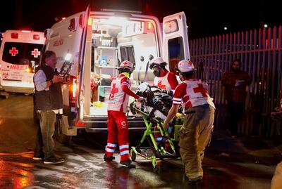 Paramedics treat an injured person after the fire at a government migration detention facility in northern Mexico. Photograph: Henrika Martinez/AFP/Getty
