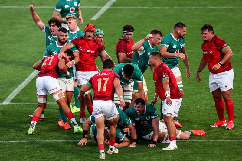 Ireland's Tom Stewart and Tom Ahern celebrate as Alex Kendellen scores his team's 14th try against Portugal. Photograph: Ben Brady/Inpho