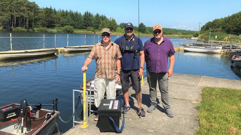 Alongside the pontoon at Carrigavantry Reservoir in Co Waterford are (from left): club chairman, William Hanrahan; RTE’s Fergal Keane and committee member, Michael Sheehan
