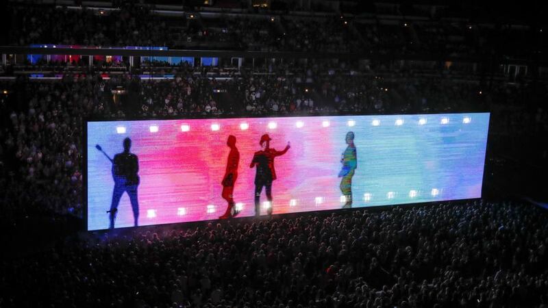 Experience + Innocence: U2 in the barricage, their double-sided video screen. Photograph: Kamil Krzaczynski/AFP/Getty