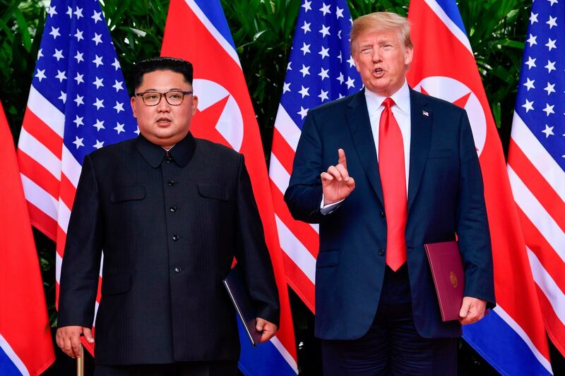 US president Donald Trump makes a statement before saying goodbye to North Korea leader Kim Jong-un (L) after their meetings at the Capella resort on Sentosa Island in Singapore on Tuesday. Photograph: Susan Walsh/AFP/Getty Images