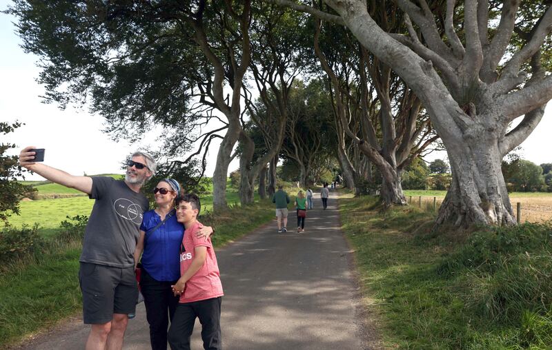 Canadian visitors Nicolas Caron, Melissa Lemieux and their 12-year-old son Cedric, from Montreal, pictured at the Dark Hedges. Photograph: Stephen Davison