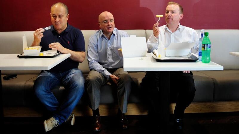 Peter Borza (left), Conor Bofin and Kevin Branigan pictured in P Borza take away in Cornmarket, Dublin, eating fish and chips. Photograph: Aidan Crawley/The Irish Times