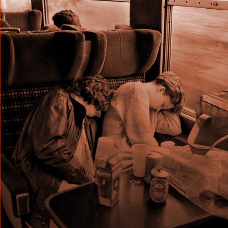 Two young women sleeping on the Holyhead train in August 1986. Photograph: Joanne O'Brien/EPIC, the Irish Emigration Museum