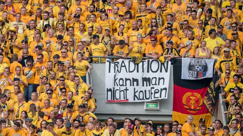 Dynamo Dresden fans hold banners reading ‘you cannot buy tradition’ and ‘No to RB’ during their German Cup first round tie with RB Leipzig. Photo: Getty Images