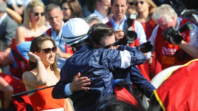 Trainer Joseph O’Brien embraces his brother Donnacha O’Brien after they combined with Latrobe to win theDubai Duty Free Irish Derby at the Curragh. Photograph: Inpho