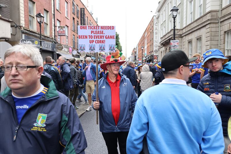 Michael Garrett, from Ballincollig, Cork, looking for a match ticket among fans who gathered on Talbot Street to commemorate War of Independence veteran Seán Treacy. Photograph: Dara Mac Dónaill









