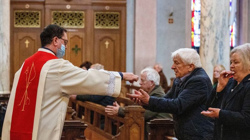 A priest hands out Holy Communion to parishioners at the Cathedral of Saint Patrick and Saint Felim, Cavan, as places of worship across Ireland were able to welcome back some members of their congregations for services on Monday. Photograph: Liam McBurney/PA Wire