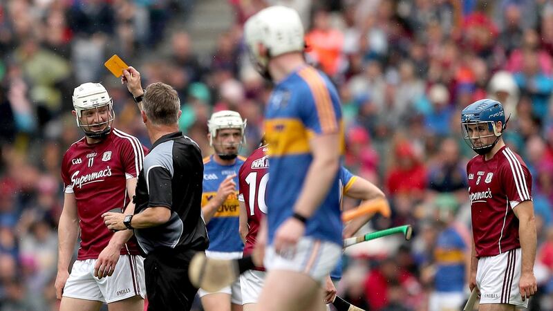 Referee Barry Kelly yellow cards Joe Canning of Galway. Photograph: James Crombie/Inpho