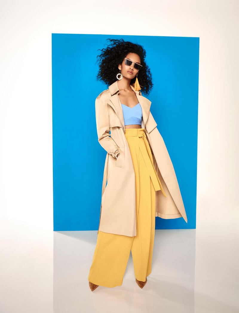 Trench coat €113, blue bra top €37, earrings €17, sunglasses €22, trousers €60, boots €75, all from River Island