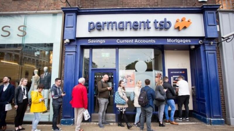 People pictured queuing at a Permanent TSB ATM on St Stephen’s Green, Dublin, on Friday evening. Photograph: Tom Honan