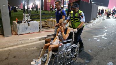 Anne-Mari Hyrylainen of Finland receives medical attention after finishing the marathon . Photograph: Ali Haider/EPA