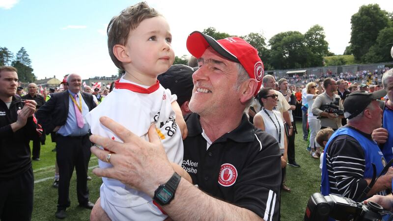 Tyrone manager Mickey Harte celebrates with his grandson Michael at the end of the game. Photograph: INPHO