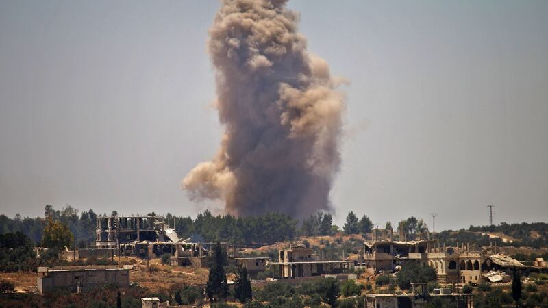Smoke rises above opposition held areas of Daraa during airstrikes by Syrian regime forces Tuesday. Photograph: Mohamad Abazeed/AFP