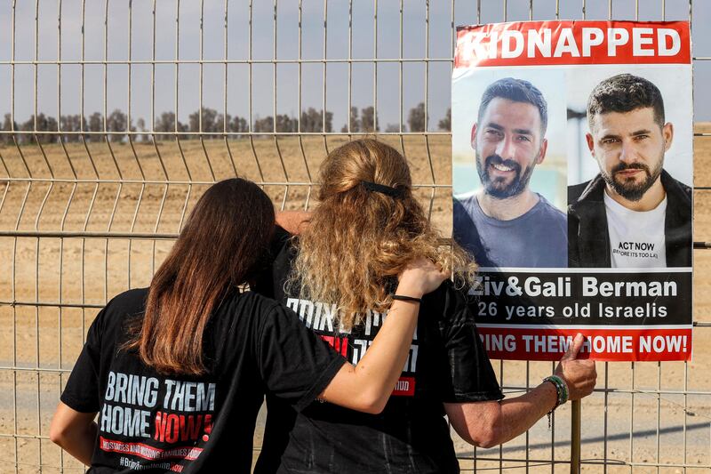 Two women stand with a sign identifying Israeli hostages Ziv and Gali Berman during a demonstration by families of hostages taken captive in the Gaza Strip since the October 7th attacks. Photograph: Jack Guez/AFP via Getty Images