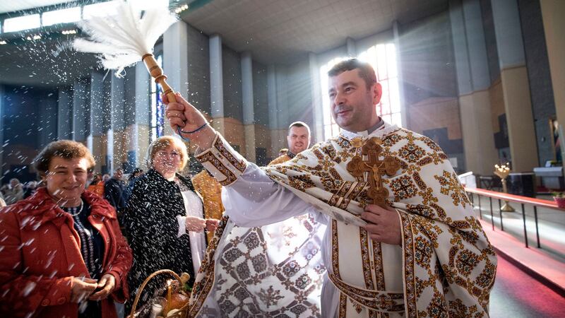 Fr Vasyl Kornitsky blesses the congregation at an Easter celebration. He is expected to lead the Christmas service at Our Lady of Consolation church in Donnycarney at noon on Saturday. Photograph: Tom Honan