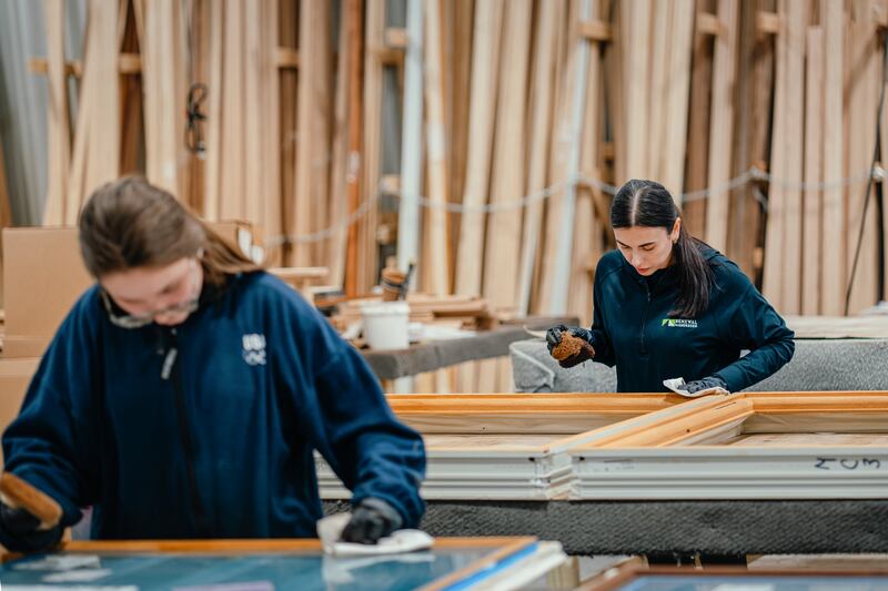 Cousins Alina Mirzoian (left) and Liana Avetisian, who fled from Kyiv two years ago, work their last day finishing window fixtures in Davenport, Iowa. Photograph: Jamie Kelter Davis/The New York Times