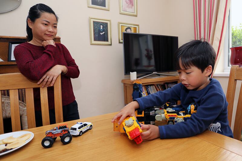 Darby's Mum, Phuong watches as he gets a last minute play in before heading off for his first day at school. Photograph: Lorraine Teevan


