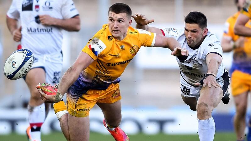 Henry Slade of Exeter Chiefs offloads as he is challenged by Xavier Mignot of Lyon during the Heineken Champions Cup round of 16 match at  Sandy Park. Photograph: Ryan Hiscott/Inpho