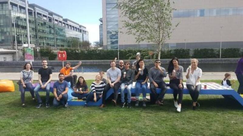 The installation is large and strong, a long blue platform which dips and rises, where people can sit, eat lunch, read, climb, chat. Photograph: A Playful City
