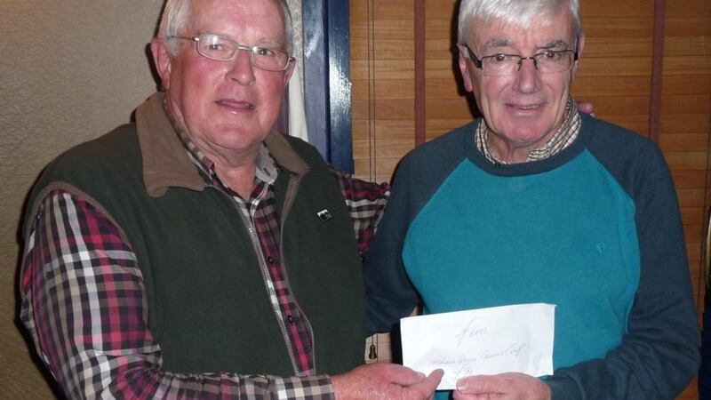 Tim O’Brien (right) accepting a cheque for €600 from Mike Hegarty towards sending special needs children to Lourdes, following the Mike Hegarty Charity Competition on Lough Lein in Killarney