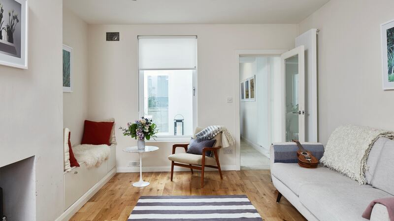 The living room with its new bigger window onto the courtyard. Photograph: Philip Lauterbach