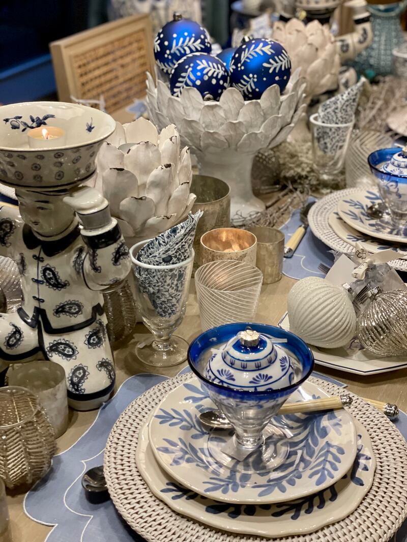 Hedgeroe home: White rattan underplate (€19); blue leaf plate (€30 each); blue edge trifle glass (set of four, €68); Rivera cutlery (set of 24 €57); coated blue linen placemat (€24); and white artichoke candle holder (€49).