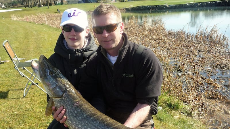 James’s St CBS transition year student, Jason Brophy with his 18lb pike, ably assisted by IFI’s Des Chew at K Club