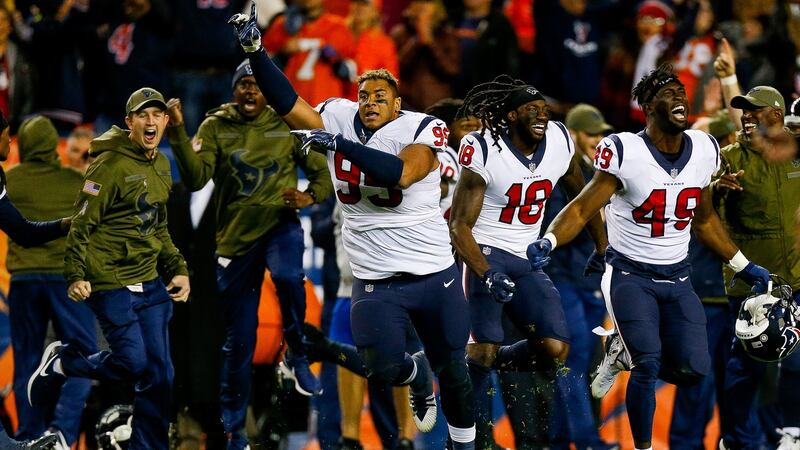 Defensive end Christian Covington, wide receiver Sammie Coates, and linebacker Josh Keyes of the Houston Texans celebrate their win over the Broncos. Photo: Justin Edmonds/Getty Images