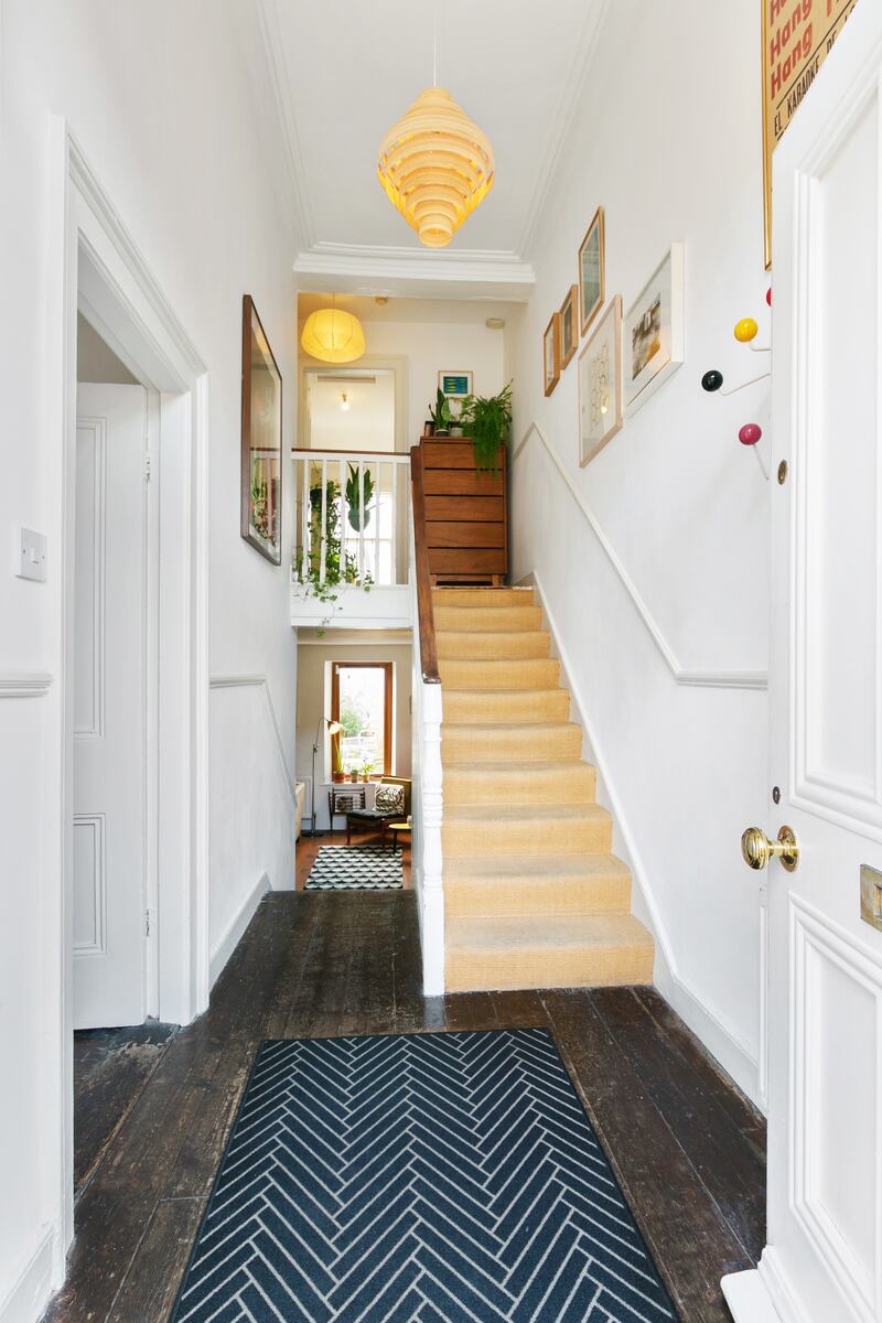 The airy entrance hallway of this Victorian villa, with four-metre-high ceilings and original wooden floors, draws the eye to the greenery of the garden at the back of the home.