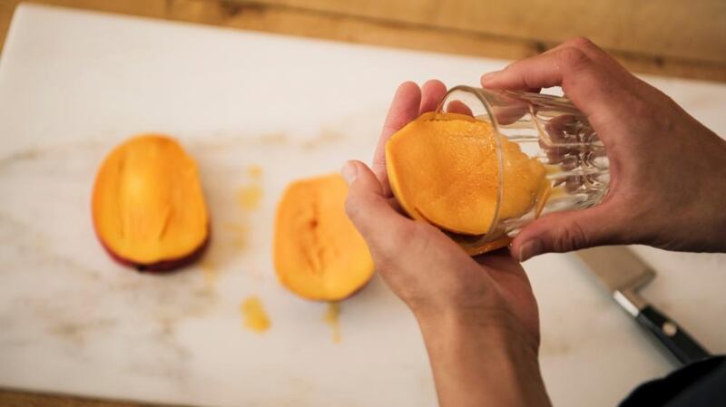 Use a glass to separate mango flesh from skin. Photograph: Linda Nylind/The Guardian