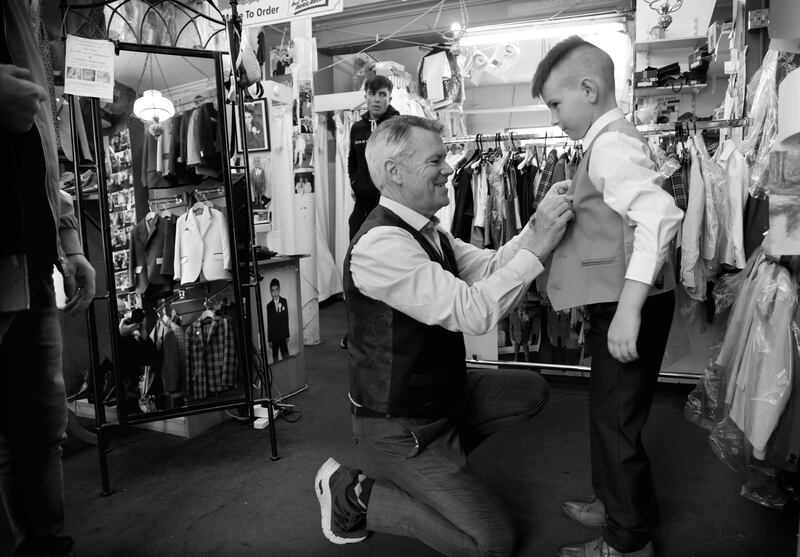 Ethan May (9) gets some help from tailor Leonard Fagan as he tries out his new Communion suit at Jas Fagan's. Photograph: Bryan O’Brien