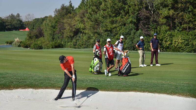 McIlroy plays a shot from a bunker. Photo: Hector Retamal/Getty Images