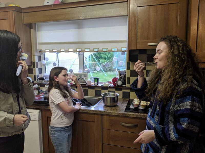 Eve, with her sisters Ellen and Katie, making cupcakes.