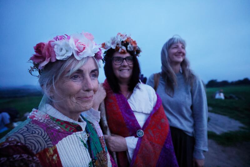 Pamela-Gail Rea from Tyrone, Anne-Marie Doherty from Antrim and Lisa Monita from Canada enjoy the solstice at Tara. Photograph: Alan Betson/The Irish Times

