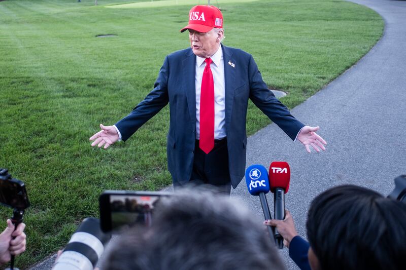 Donald Trump speaks to reporters at the White House on Sunday. Photograph: Pete Marovich/The New York Times