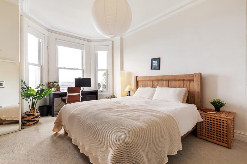 First floor bedroom with deep bay window and sea views.