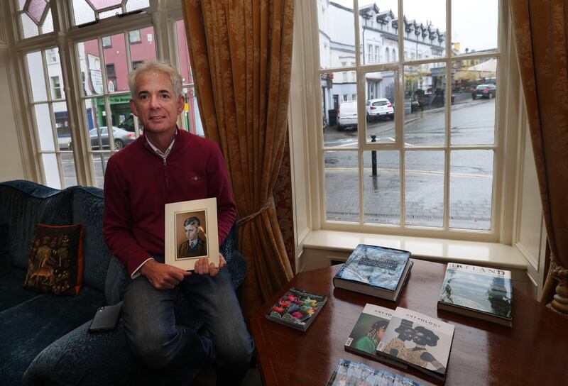 Sean Buckley, proprietor of the Arbutus Hotel in Killarney, holds a  copy of the portrait of his father Pat, painted by Harry Kernoff in 1943. Photograph: Bryan O’Brien
