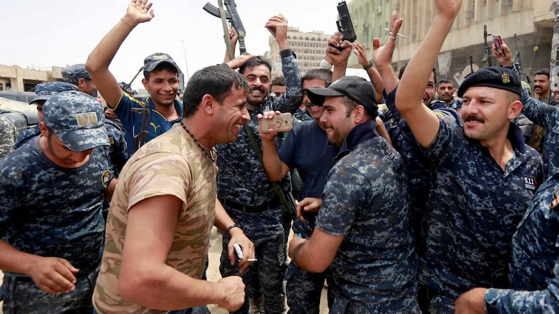 Iraqi federal police celebrate in the Old City of Mosul on Saturday. Photograph: Ahmed Saad/Reuters