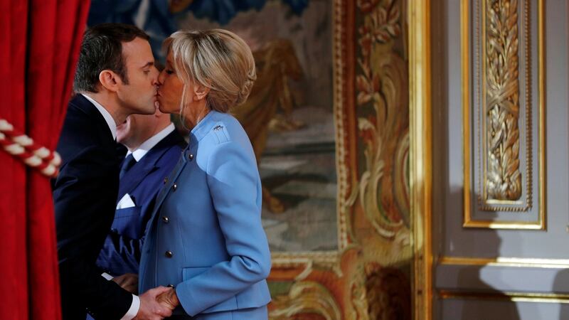 French president Emmanuel Macron kisses his wife Brigitte Trogneux during the handover ceremony in Paris on Sunday. Photograph: Philippe Wojazer/Reuters