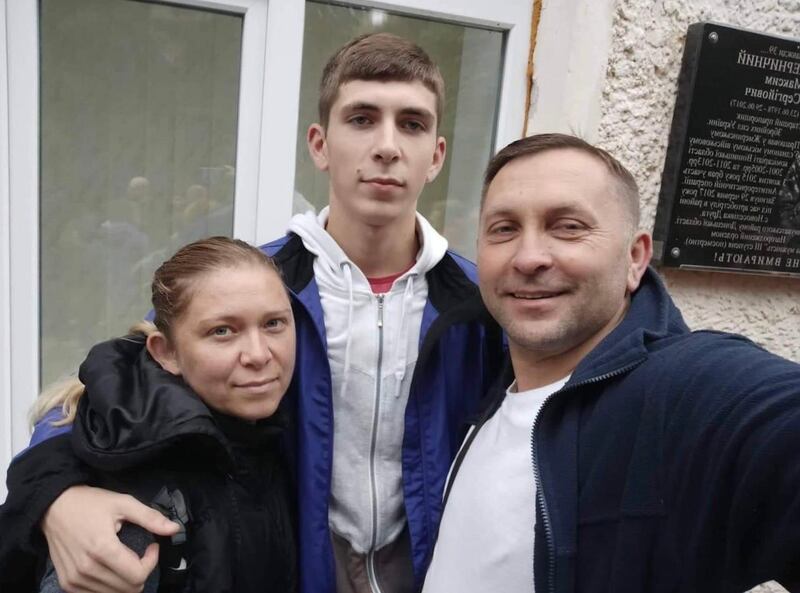 Ukrainian border guard Mark (19) with his mother and father before he was deployed to Mariupol in south-eastern Ukraine. Photograph courtesy Mark's family.