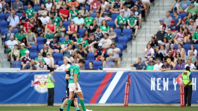 Ireland outhalf Joey Carbery leaves the field injured. Photograph:  Ryan Byrne/Inpho