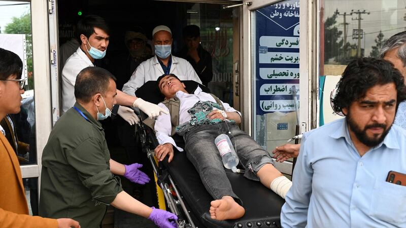 Medical staff move a wounded youth on a stretcher inside a hospital in Kabul after bomb blasts rocked a boys’ school in a Shia Hazara neighbourhood. Photograph:  Wakil Kohsar/AFP
